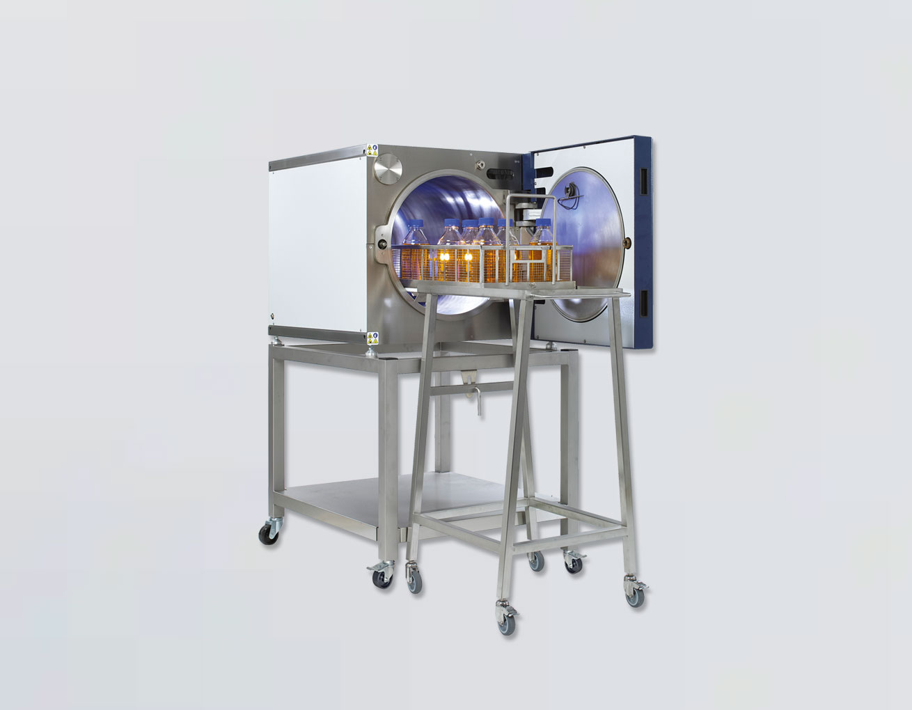 Woman operating a sterilization machine.