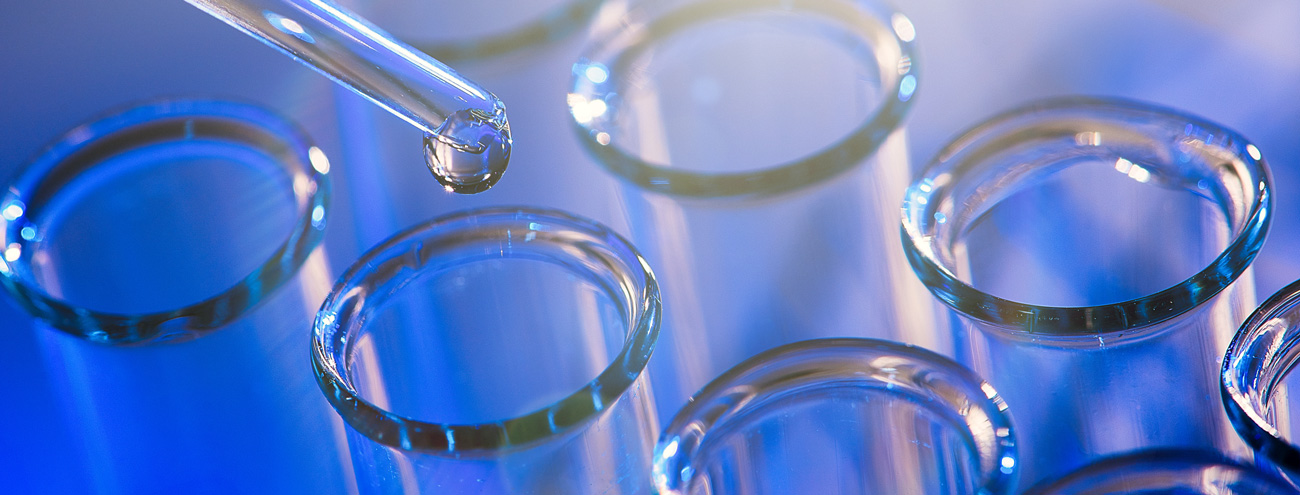 Several pipettes and test tubes on a blue background